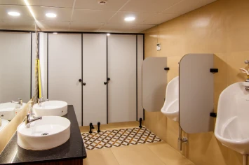 Contemporary toilet space with tiled walls and minimalist fixtures – Neo office design