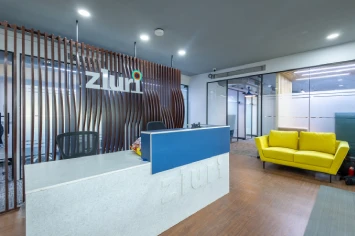 Dynamic office reception with vibrant design elements – Zluri project