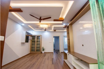 Spacious Hall with warm lighting and wood finishes – Prasad residence